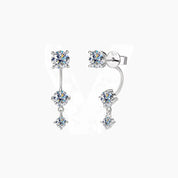 Floating three-stone moissanite drop earrings in white gold vermeil, front and side views.