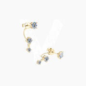 Floating three-stone moissanite drop earrings in yellow gold vermeil, angled view.