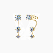 Floating three-stone moissanite drop earrings in yellow gold vermeil, front and side views.