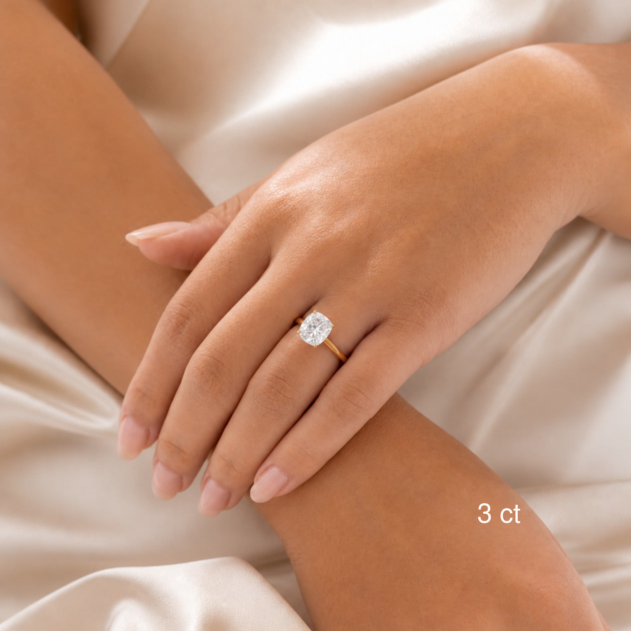 3 ct cushion-cut hidden halo ring in yellow gold worn on model