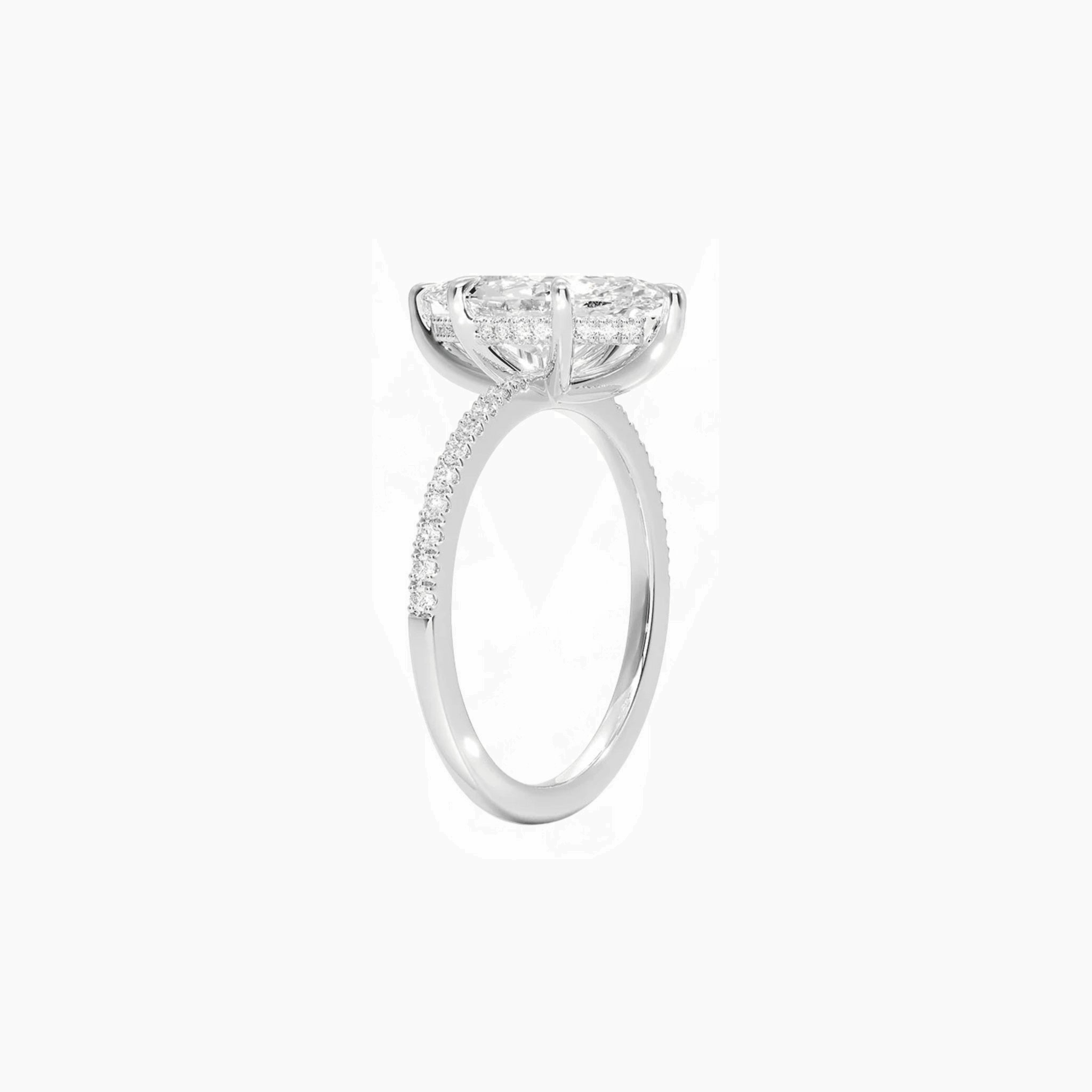 Marquise-cut moissanite hidden halo ring with pavé band in white gold vermeil, side view.