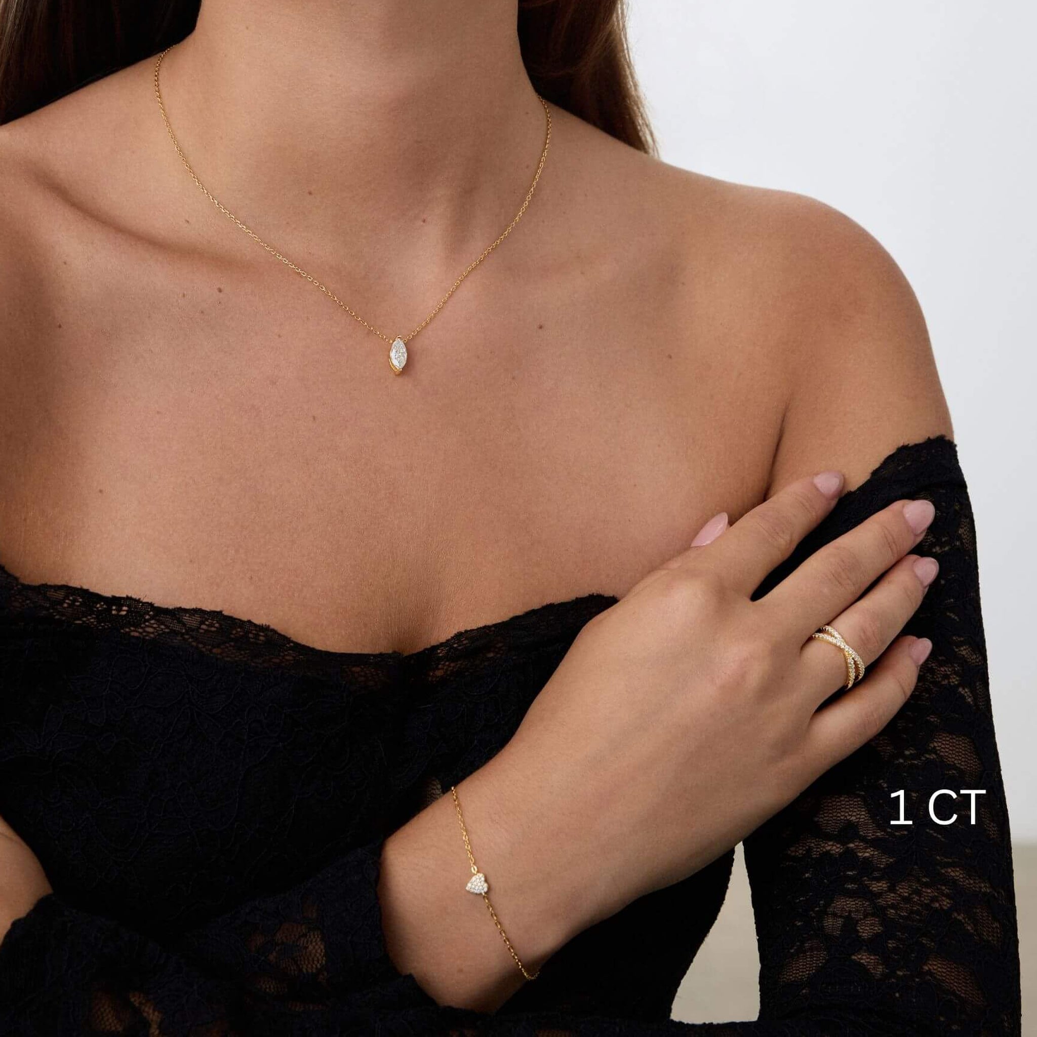 Marquise-cut moissanite pendant necklace worn at the neckline.