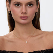 Marquise-cut moissanite pendant necklace worn at the neckline.