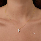 Marquise-cut moissanite pendant necklace worn at the neckline.