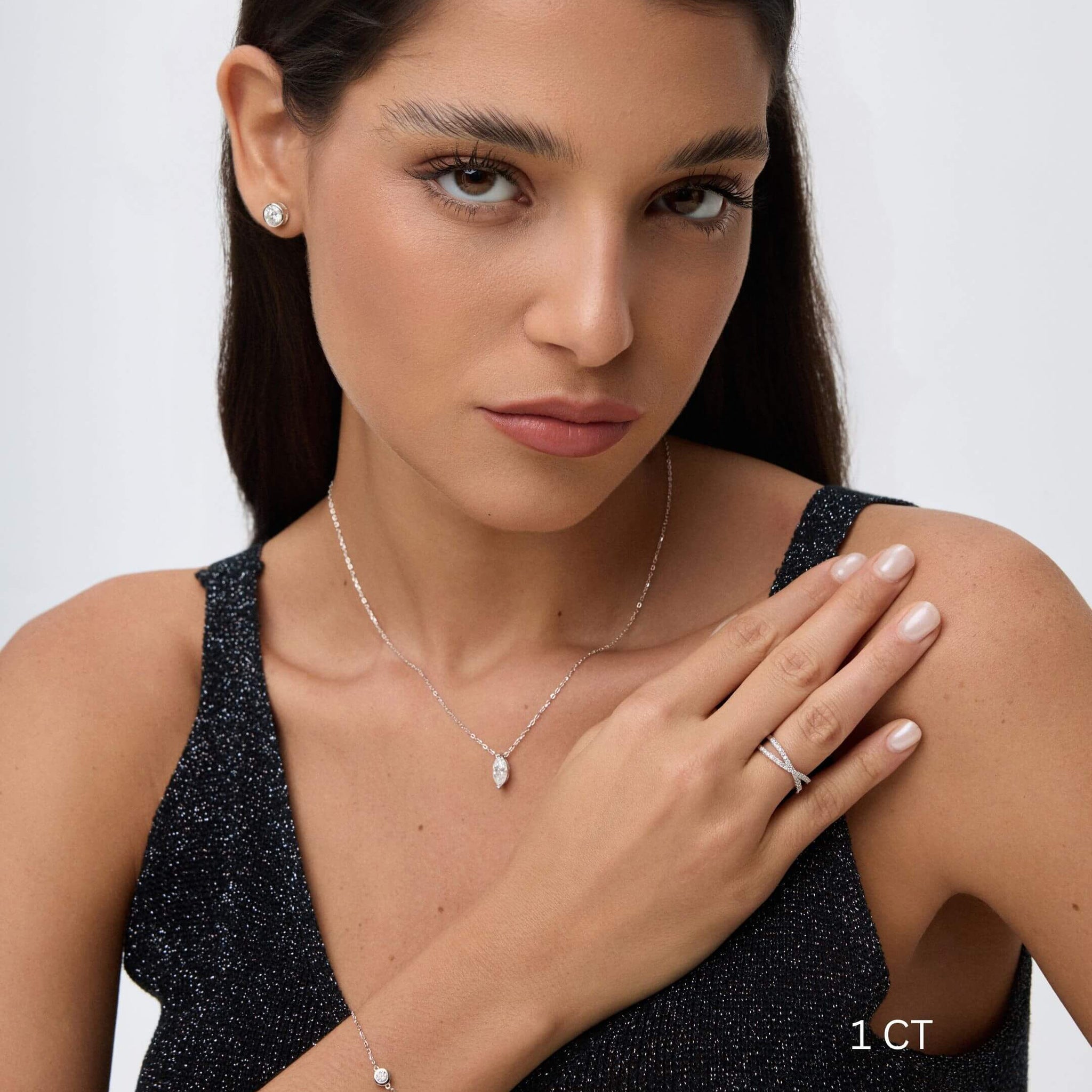 Marquise-cut moissanite pendant necklace worn at the neckline.