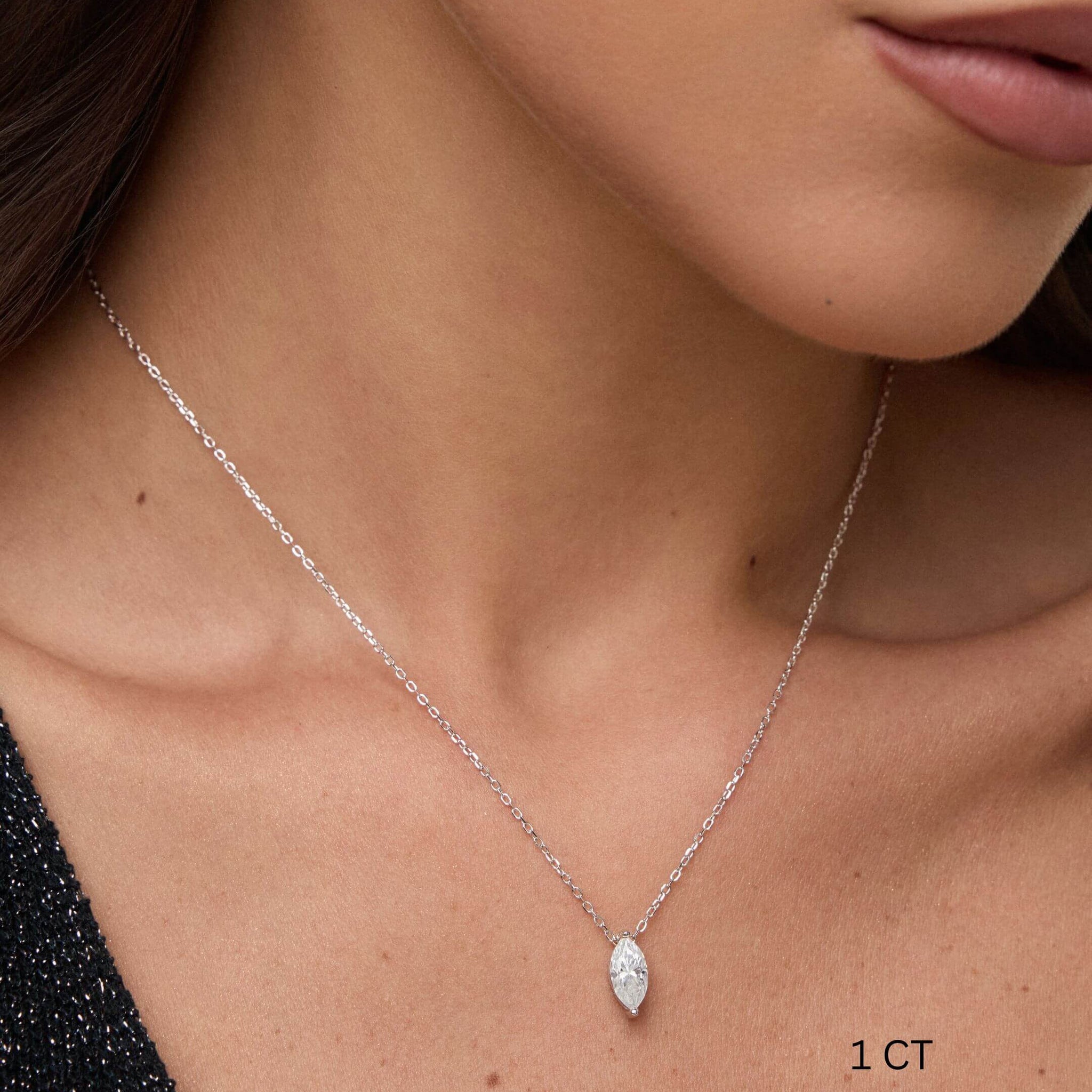 Marquise-cut moissanite pendant necklace worn at the neckline.