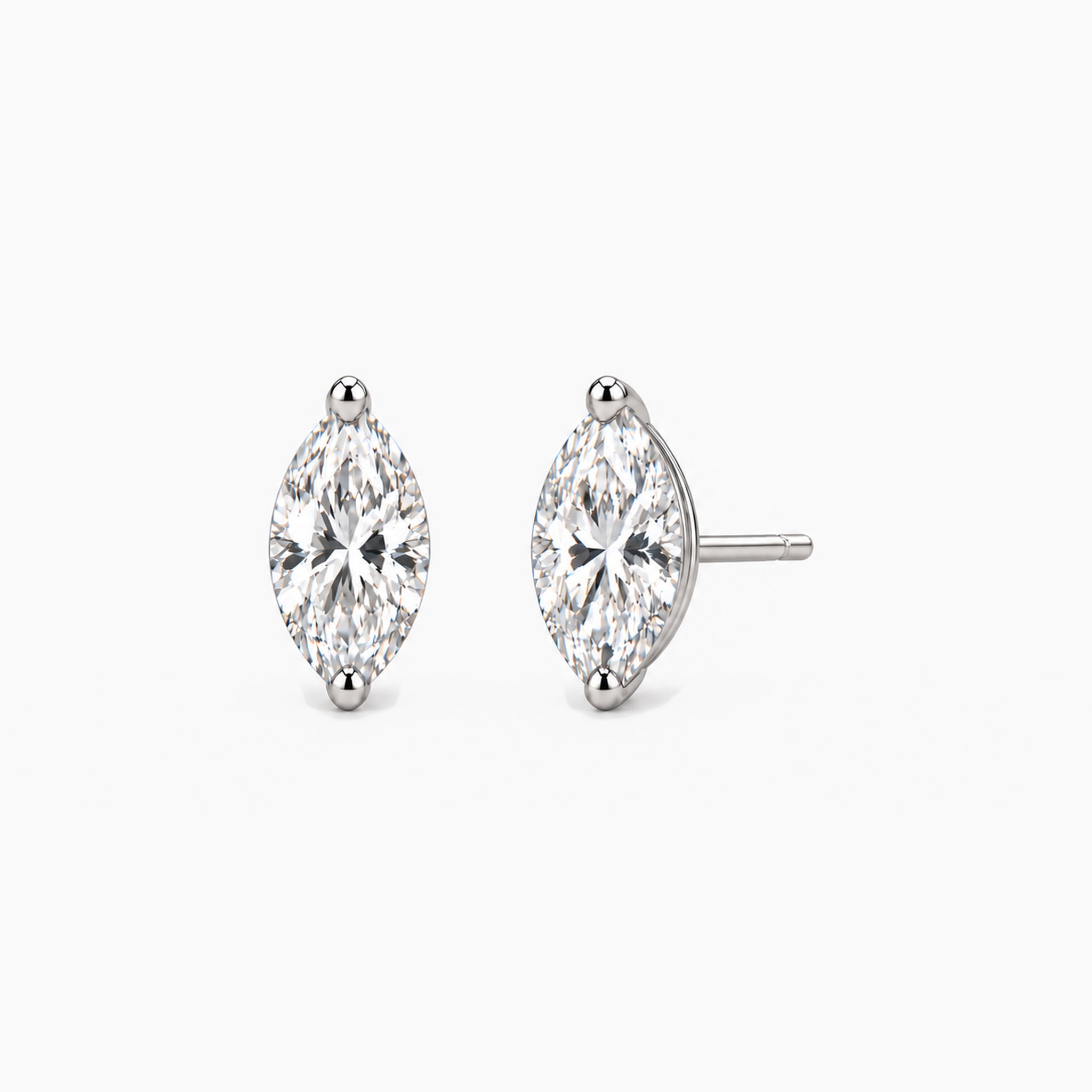 Marquise-cut moissanite stud earrings in white gold vermeil, front and three-quarter views.