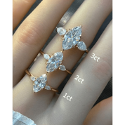 Marquise-cut moissanite three-stone ring rings arranged across fingers for a carat-size comparison.