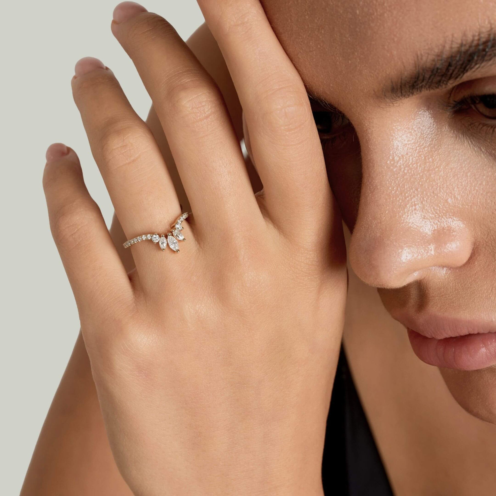 Marquise-cut moissanite trio ring worn on a finger.