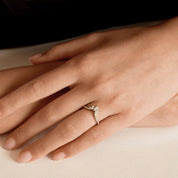 Marquise-cut moissanite trio ring worn on a finger.