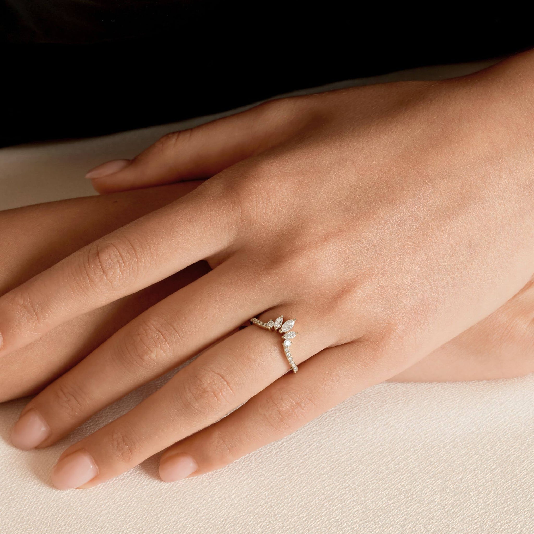Marquise-cut moissanite trio ring worn on a finger.