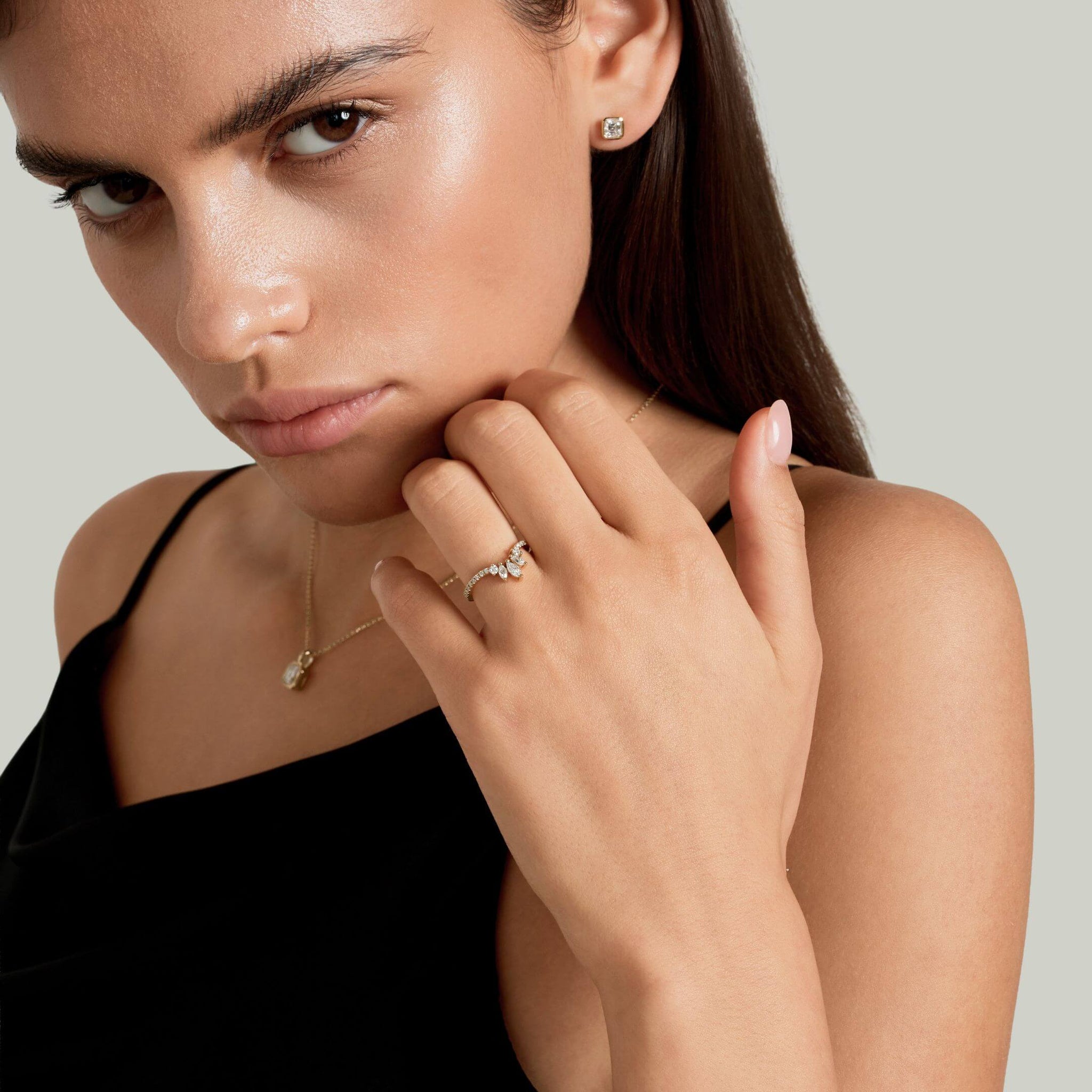 Marquise-cut moissanite trio ring worn on a finger.