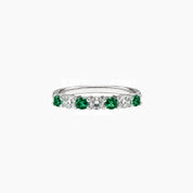 Moissanite and lab-grown emerald half eternity ring in white gold vermeil, front view.