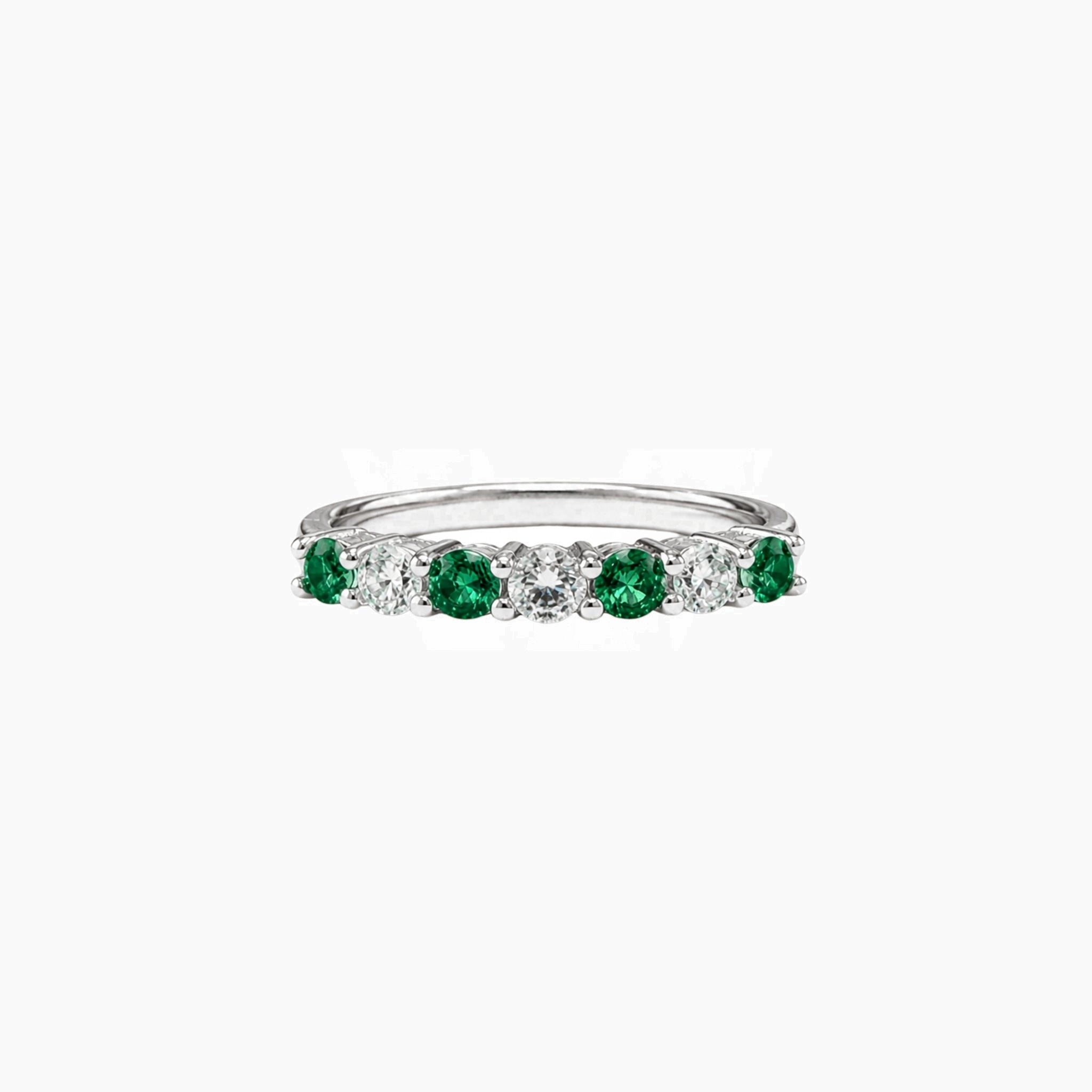 Moissanite and lab-grown emerald half eternity ring in white gold vermeil, front view.