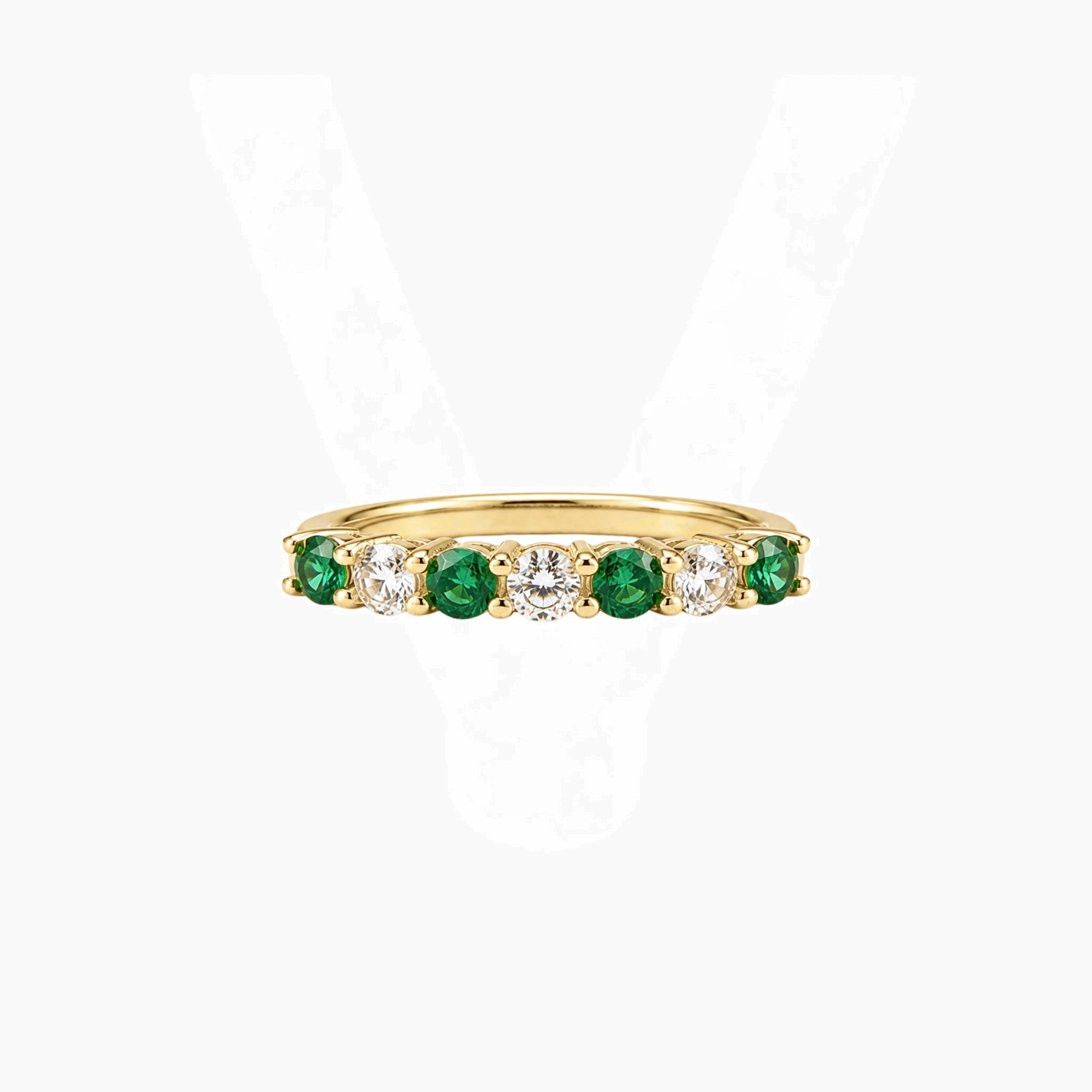 Moissanite and lab-grown emerald half eternity ring in yellow gold vermeil, front view.