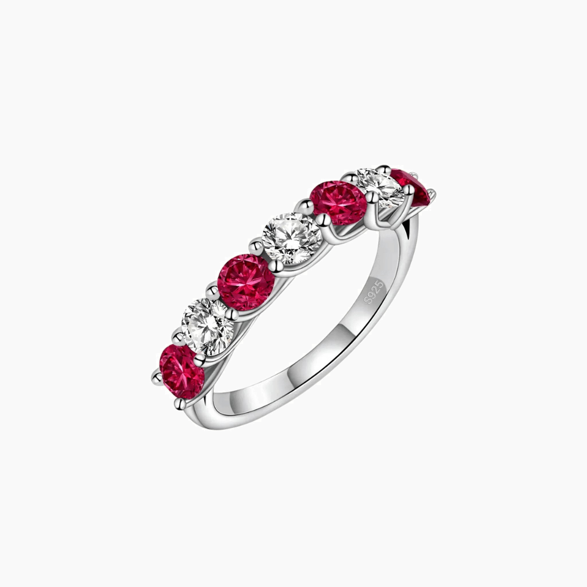 Moissanite and lab-grown ruby half eternity ring in white gold vermeil, angled view.