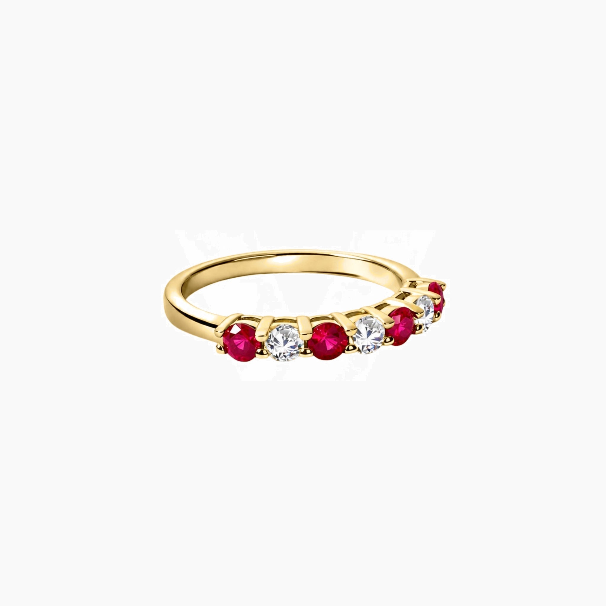 Moissanite and lab-grown ruby half eternity ring in yellow gold vermeil, angled view.