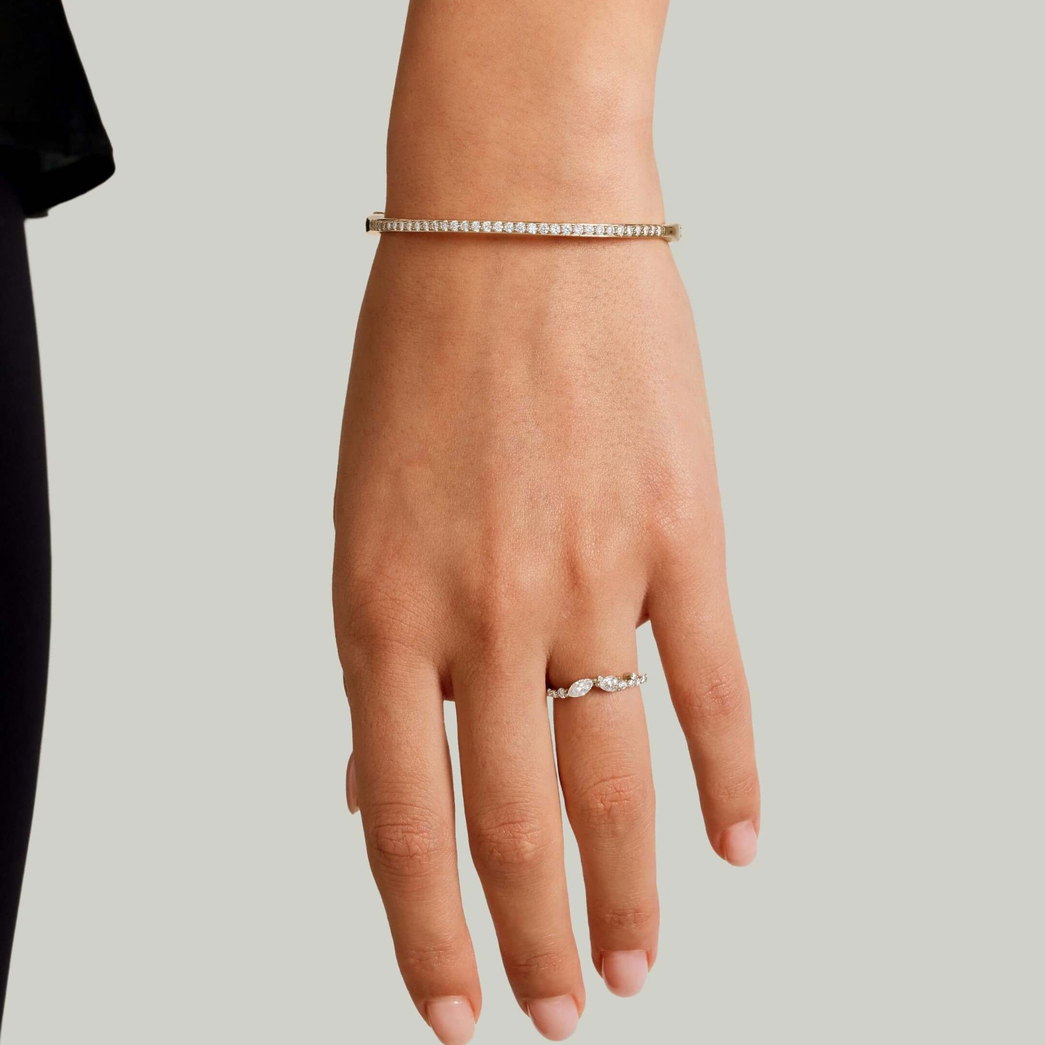 Moissanite bangle bracelet worn on the wrist.