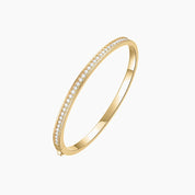 Moissanite bangle bracelet in yellow gold vermeil, angled view.