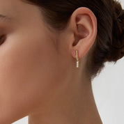 Moissanite bar drop earrings worn on the ear.