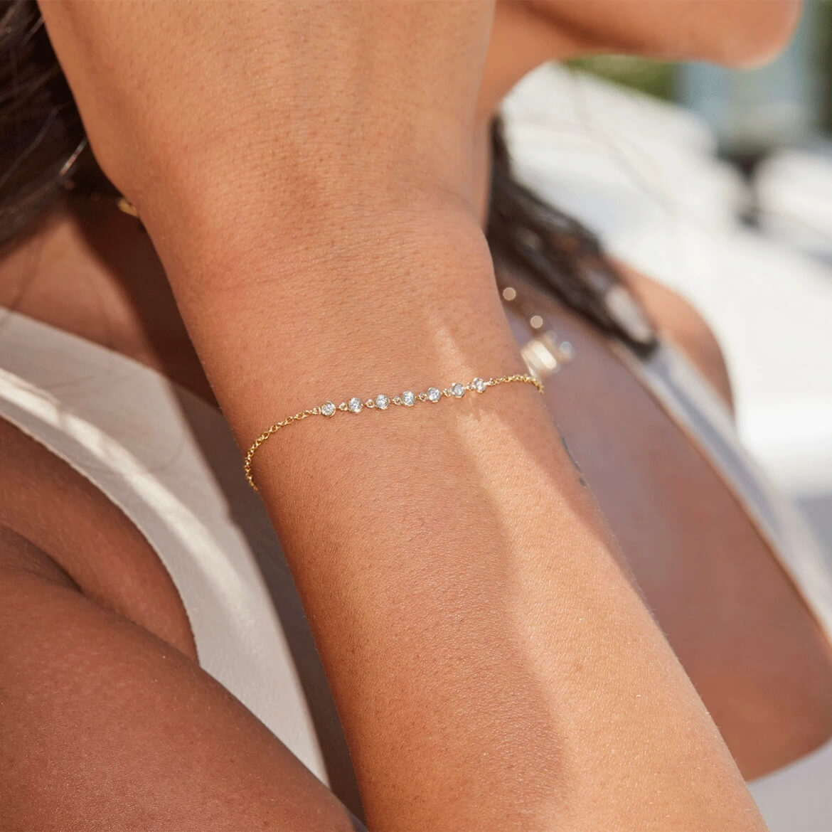 Moissanite bezel half tennis bracelet worn on the wrist.