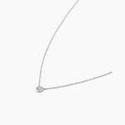 Moissanite bezel pendant necklace in white gold vermeil, side view.