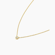 Moissanite bezel pendant necklace in yellow gold vermeil, side view.