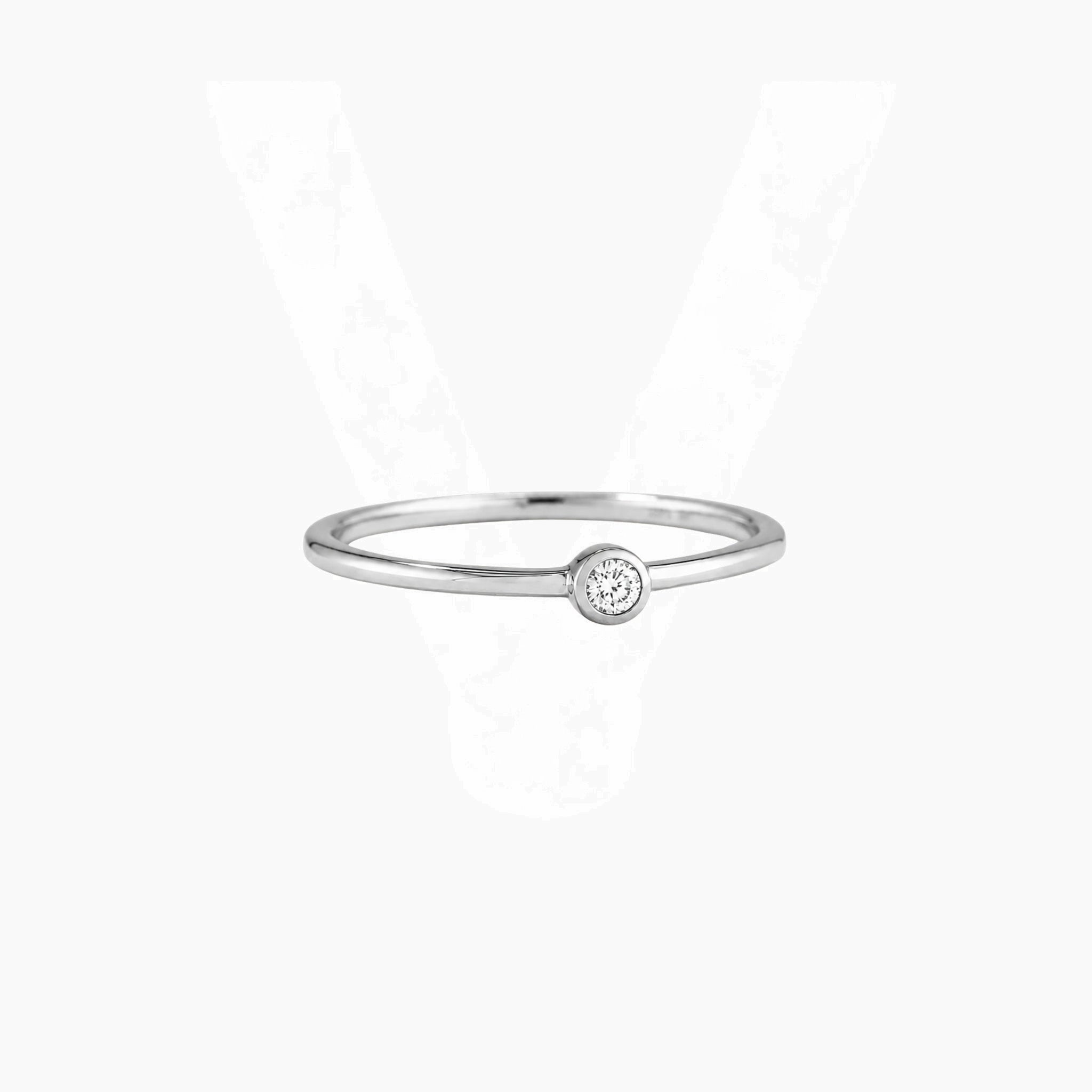 Moissanite bezel solitaire ring in white gold vermeil, front view.