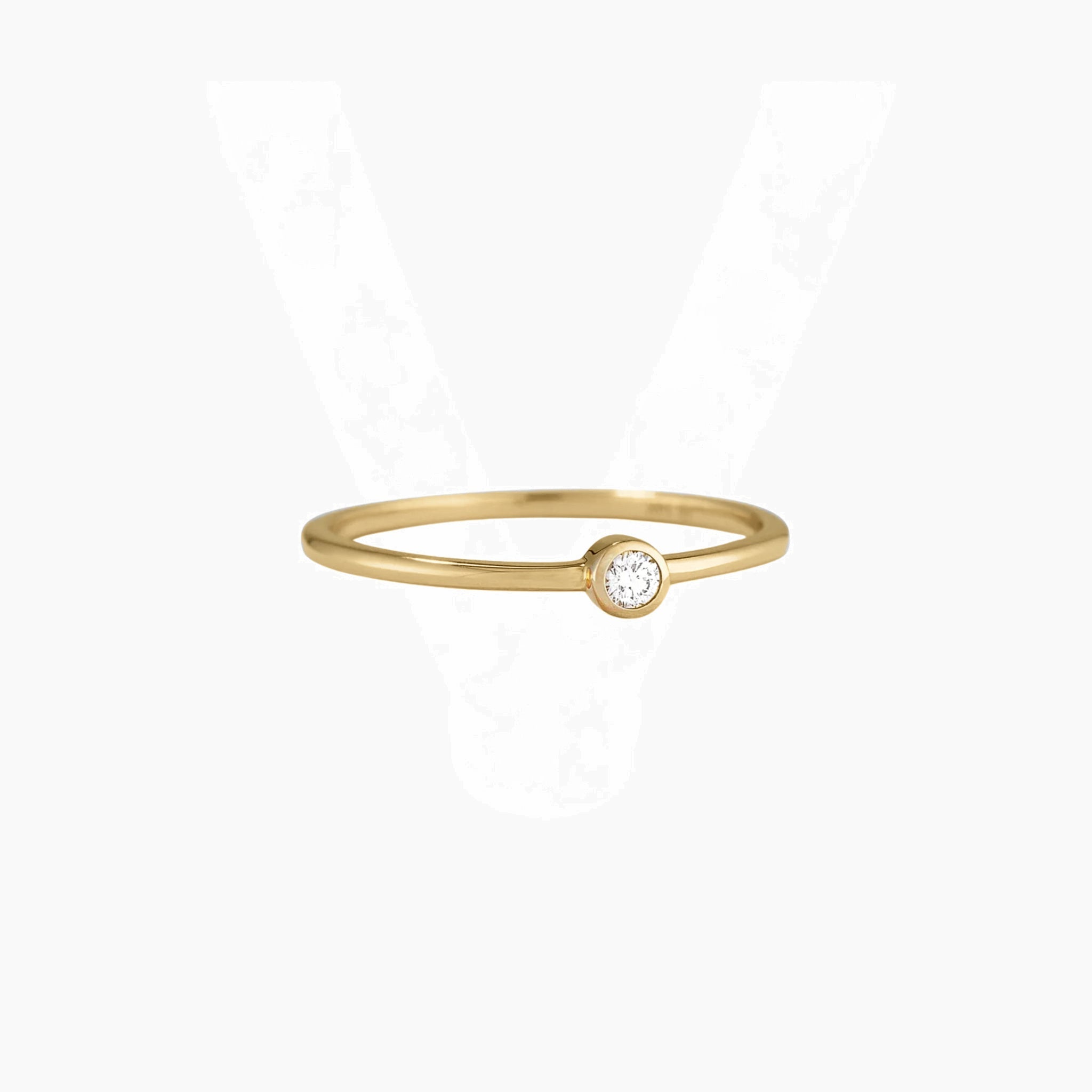 Moissanite bezel solitaire ring in yellow gold vermeil, front view.