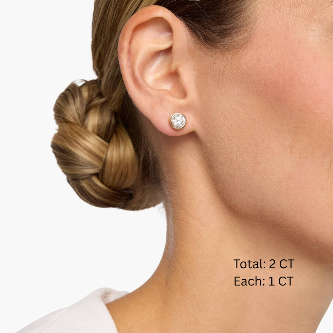Moissanite bezel stud earrings worn on the ear, 2 ct per pair with 1 ct per stone.