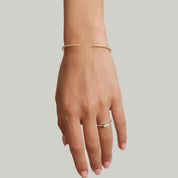 Moissanite claw cuff bracelet worn on the wrist.