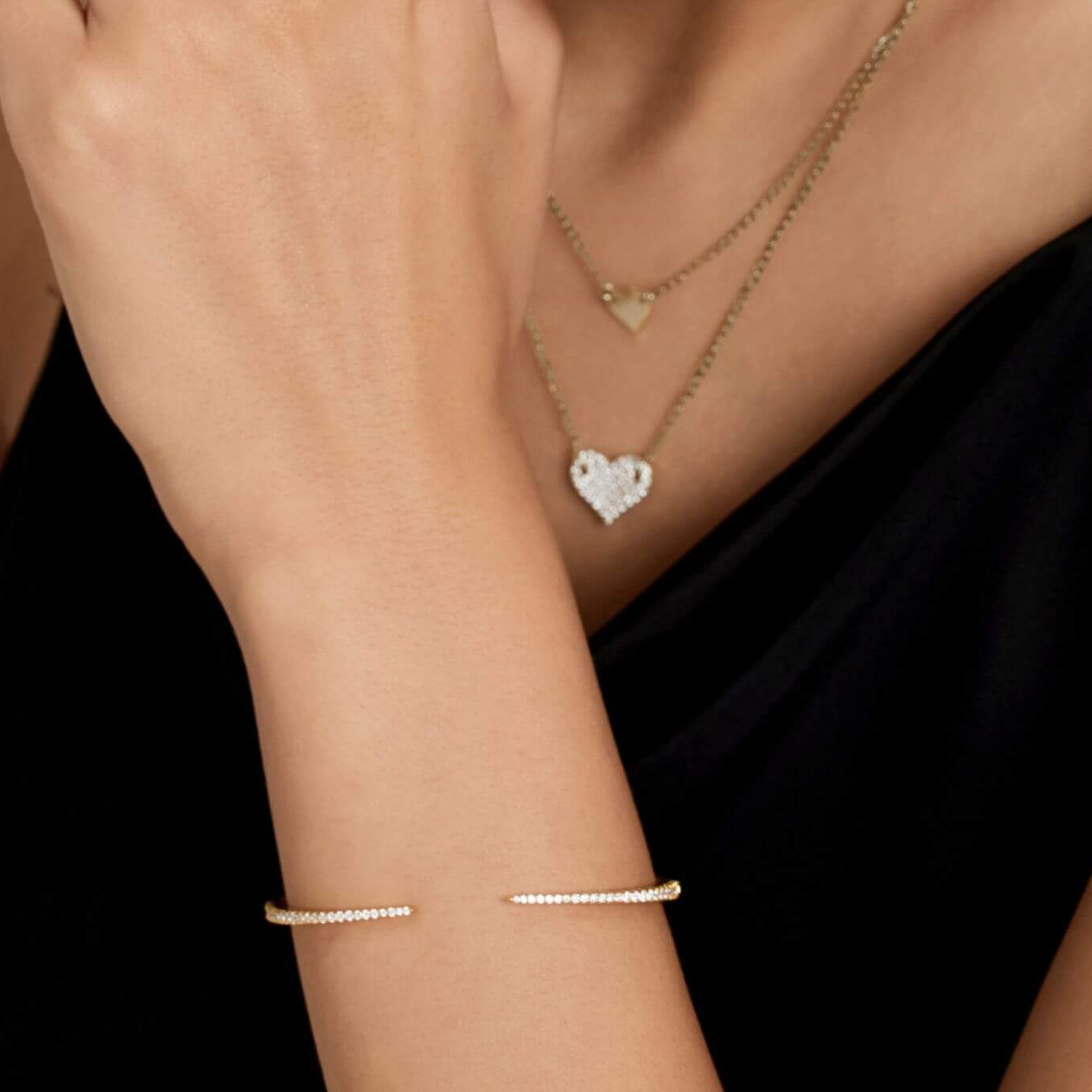Moissanite claw cuff bracelet worn on the wrist.