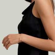 Moissanite claw cuff bracelet worn on the wrist.