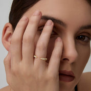 Moissanite claw ring worn on a finger.