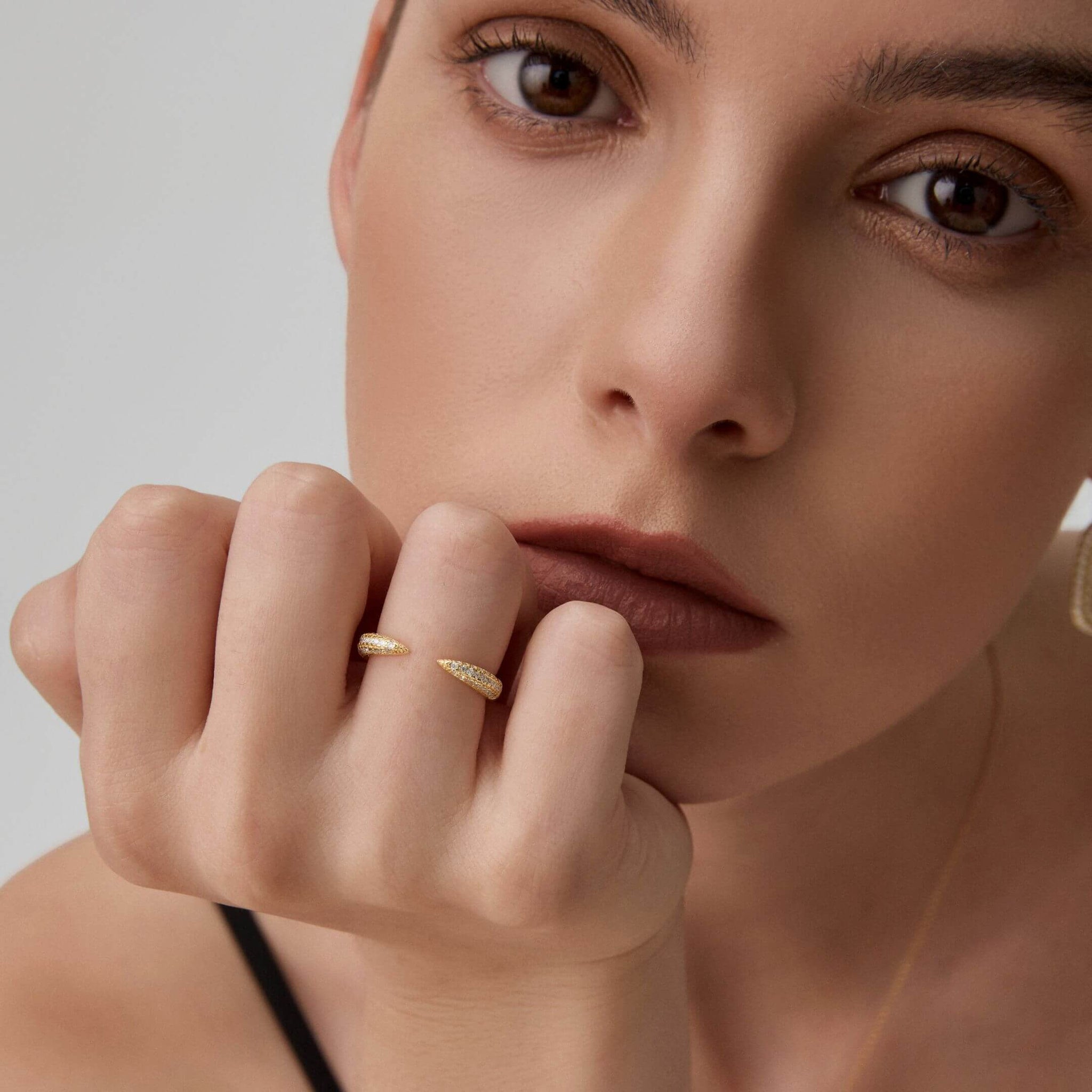 Moissanite claw ring worn on a finger.
