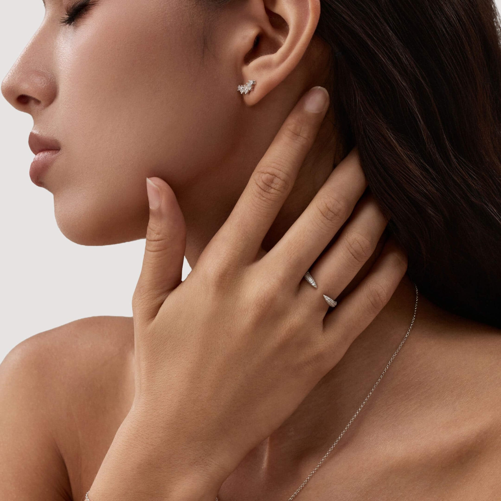 Moissanite claw ring worn on a finger.