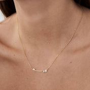 Moissanite cluster bar necklace worn at the neckline.