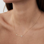 Moissanite cluster bar necklace worn at the neckline.