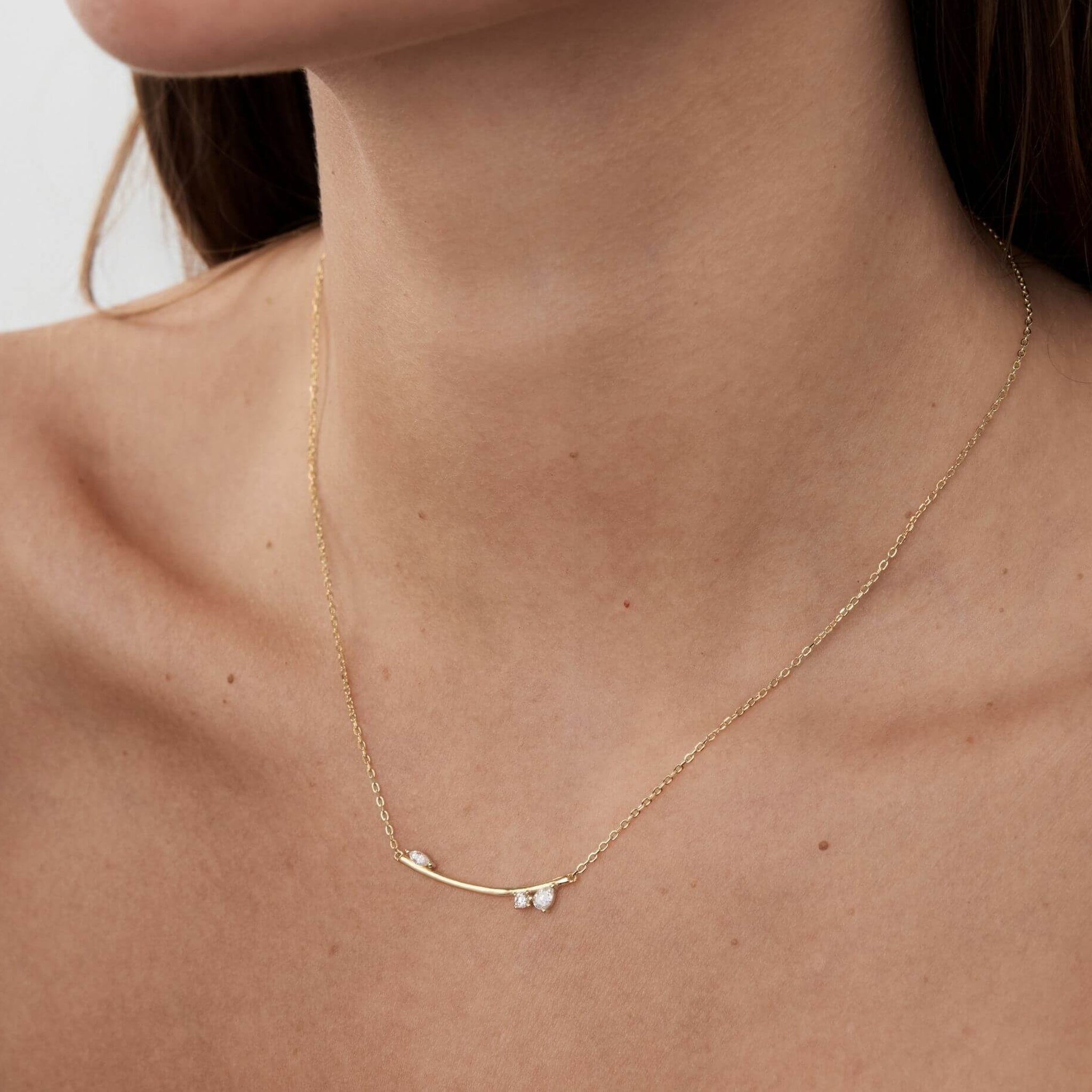 Moissanite cluster bar necklace worn at the neckline.