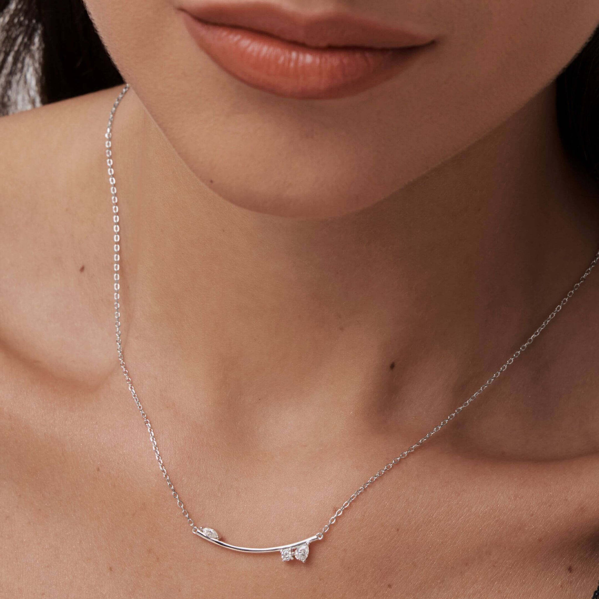 Moissanite cluster bar necklace worn at the neckline.