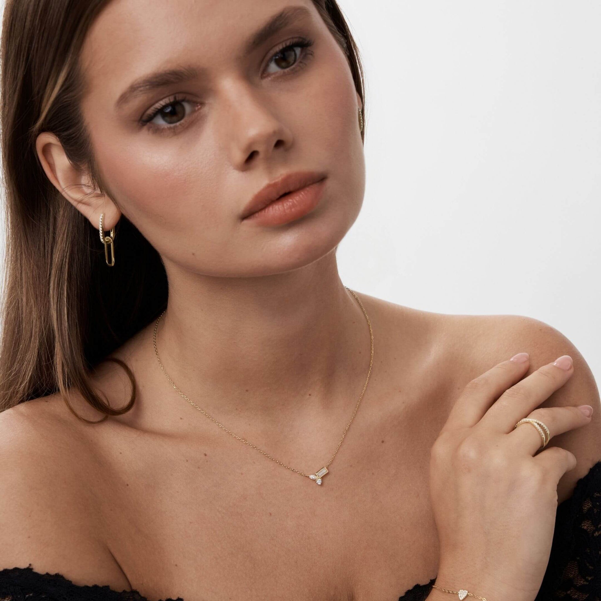 Moissanite cluster necklace worn at the neckline.