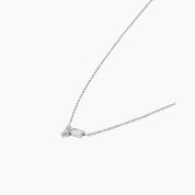 Moissanite cluster necklace in white gold vermeil, side view.