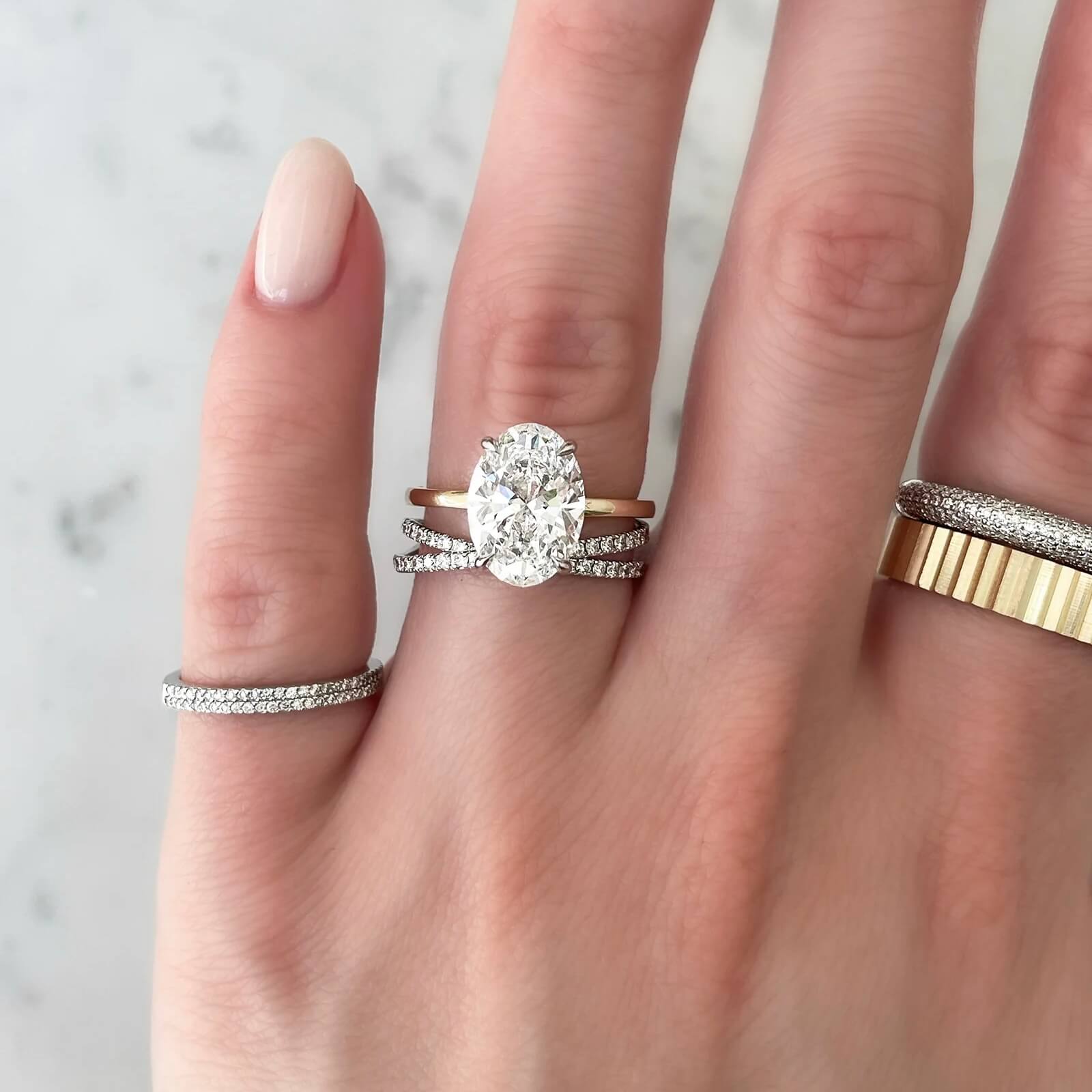 Moissanite crisscross ring worn on a finger.