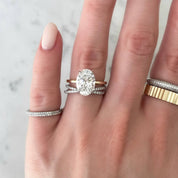 Moissanite crisscross ring worn on a finger.