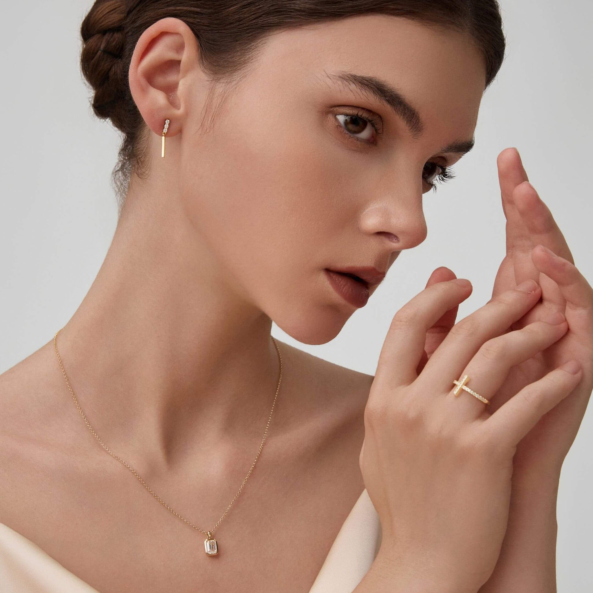 Moissanite cross ring worn on a finger.