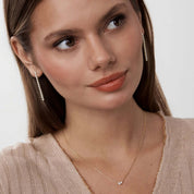 Moissanite duo necklace worn at the neckline.