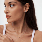 Moissanite duo necklace worn at the neckline.