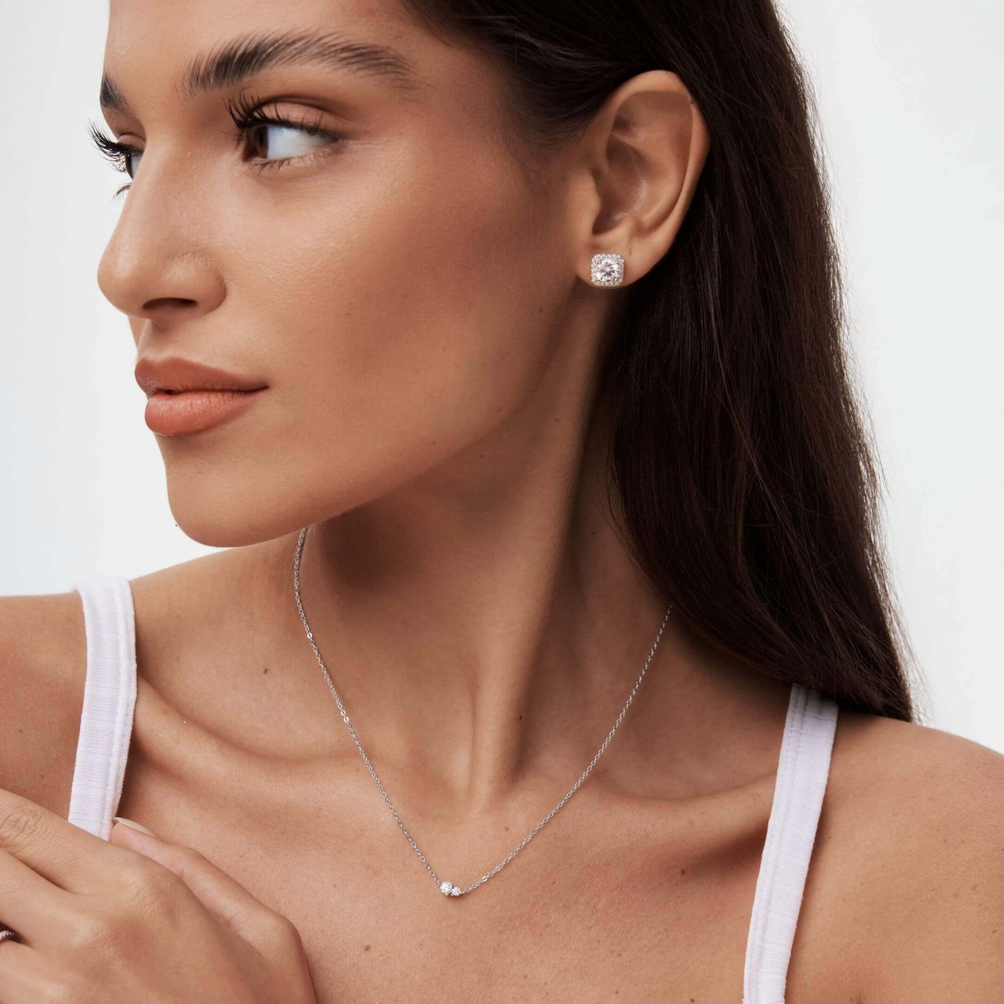 Moissanite duo necklace worn at the neckline.