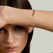 Moissanite flexible cuff bracelet worn on the wrist.