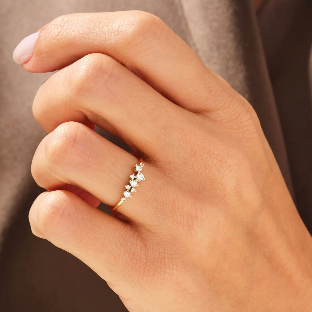 Moissanite floating cluster ring worn on a finger.